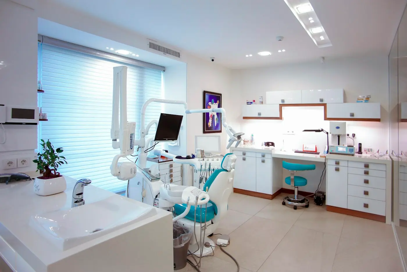 Bright treatment room with a dental chair and window light